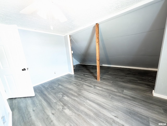 interior space featuring ceiling fan, dark hardwood / wood-style flooring, and a textured ceiling