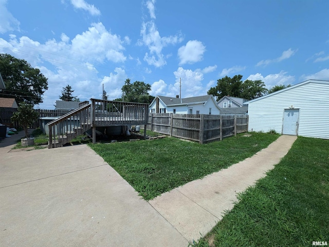 view of yard featuring a deck and fence