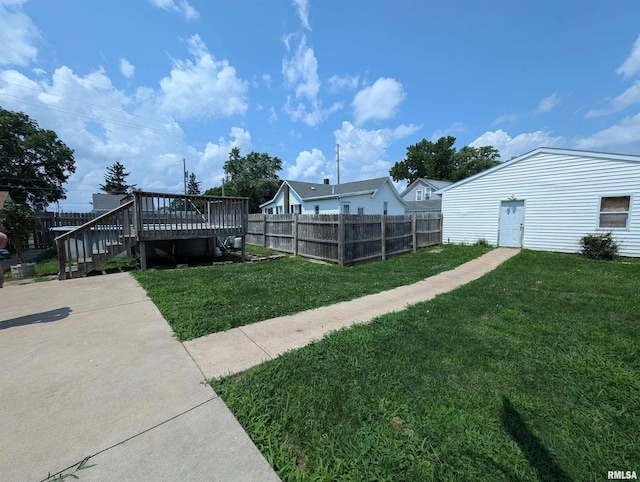 view of yard with fence and a deck