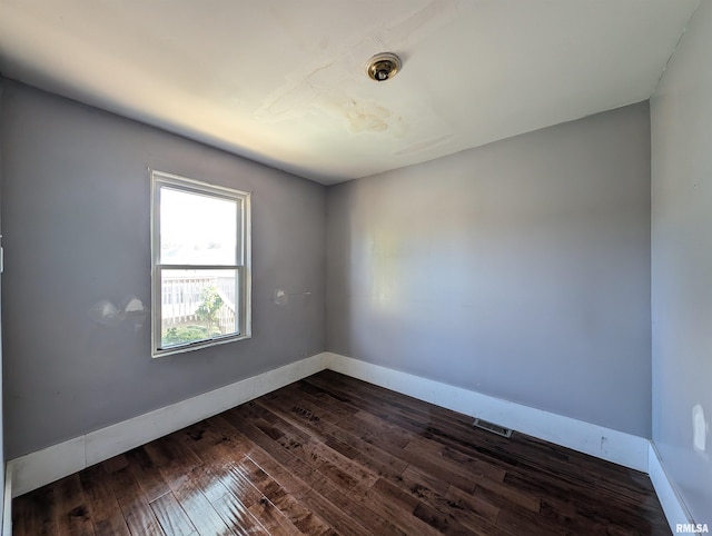 empty room with dark wood-type flooring