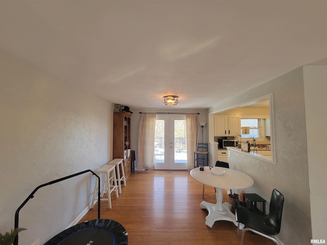 interior space with french doors and light hardwood / wood-style floors