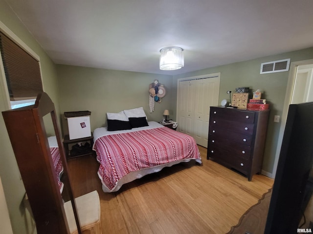 bedroom featuring hardwood / wood-style floors and a closet