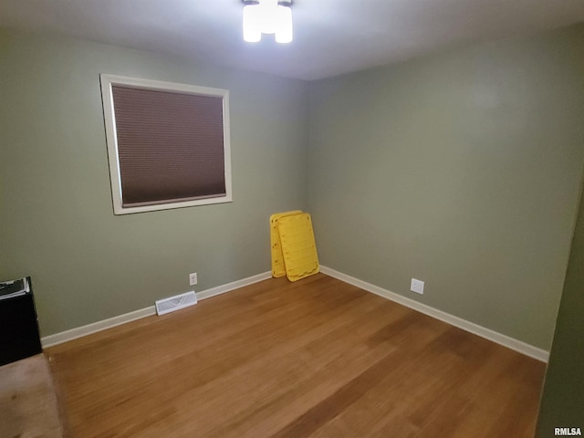 empty room with hardwood / wood-style floors