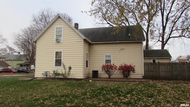 rear view of house featuring a lawn