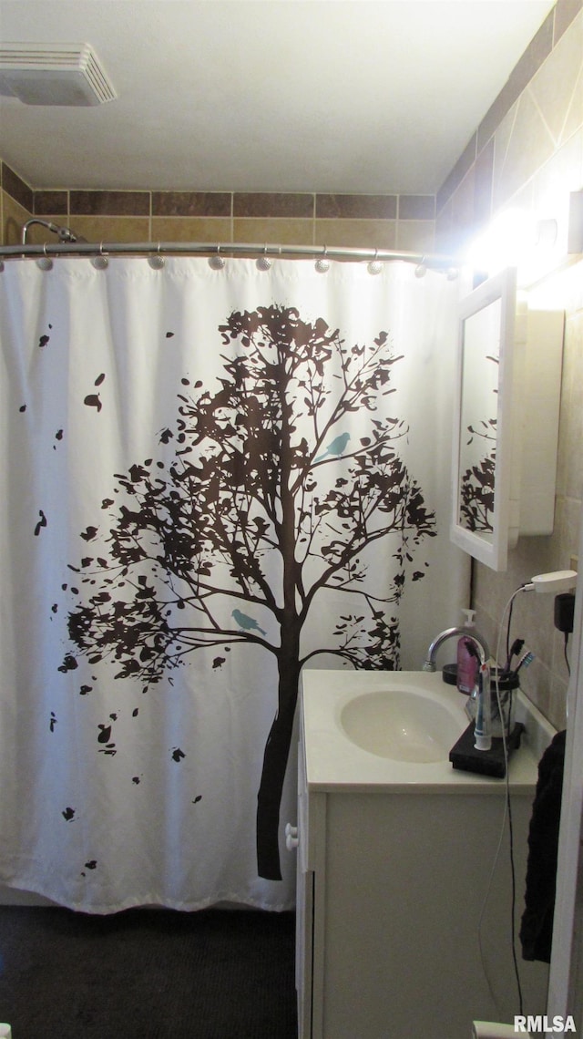 bathroom featuring vanity and curtained shower