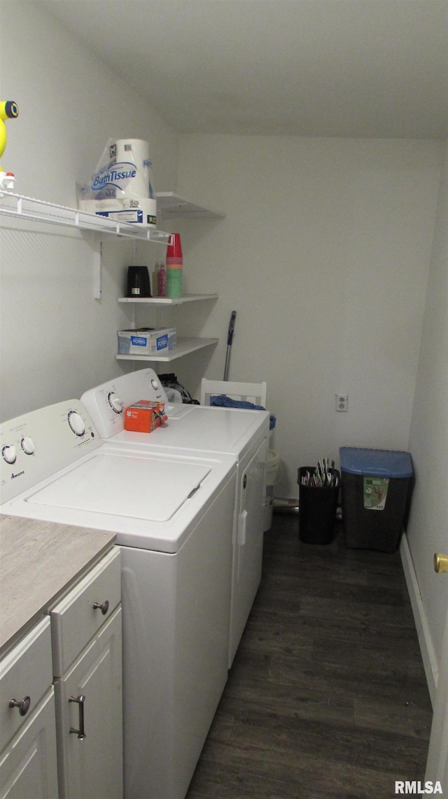 washroom featuring washer and clothes dryer, dark hardwood / wood-style floors, and cabinets