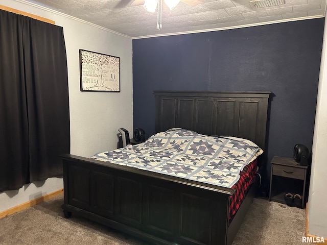 bedroom featuring a textured ceiling, ceiling fan, carpet floors, and ornamental molding