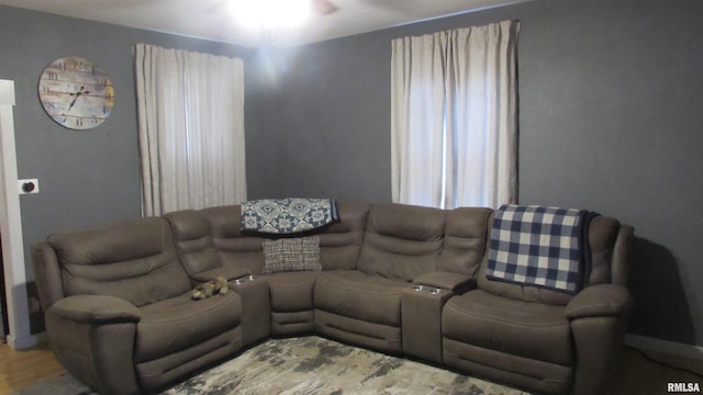 living room with hardwood / wood-style flooring and ceiling fan