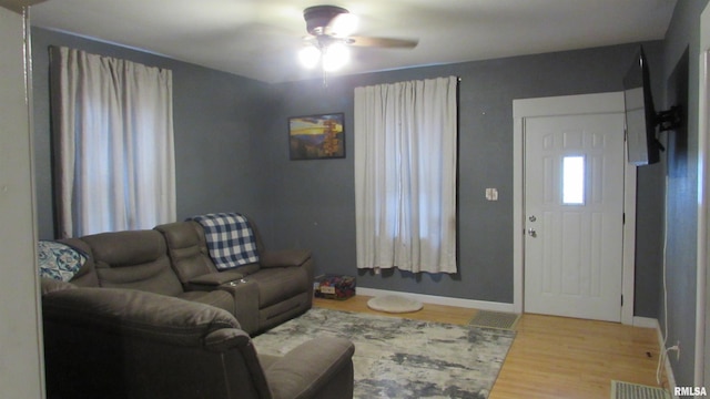 living room with wood-type flooring and ceiling fan