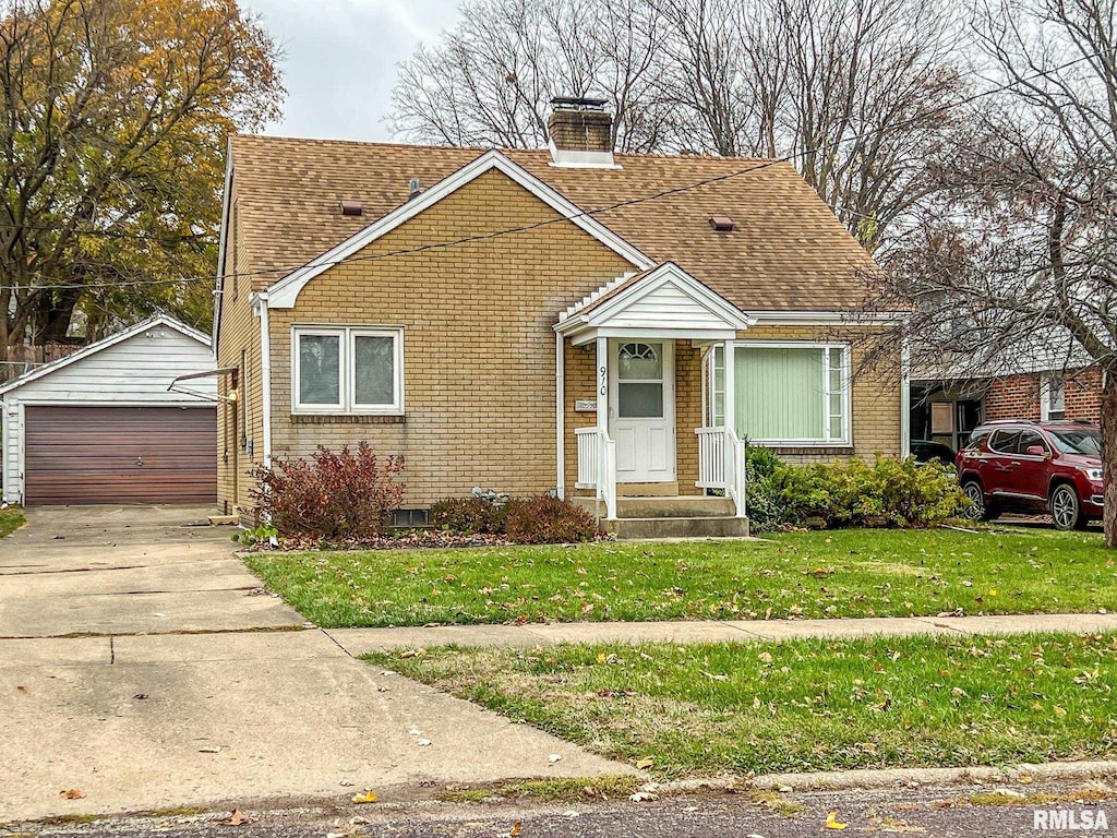 bungalow-style home featuring an outbuilding, a garage, and a front lawn