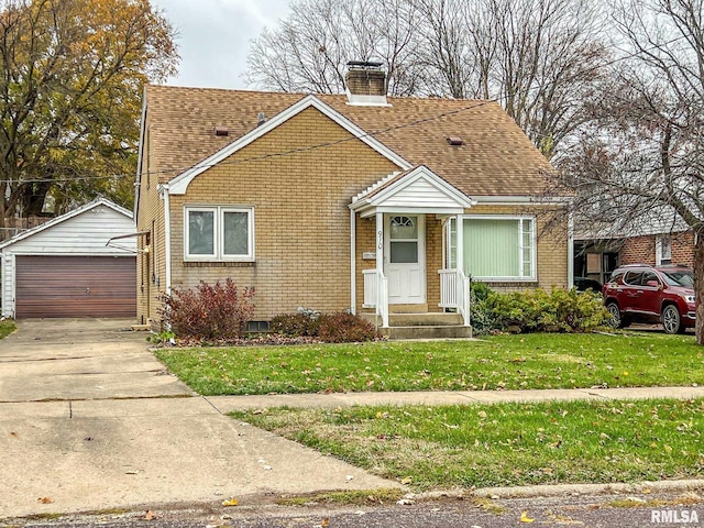 bungalow-style home featuring an outbuilding, a garage, and a front lawn