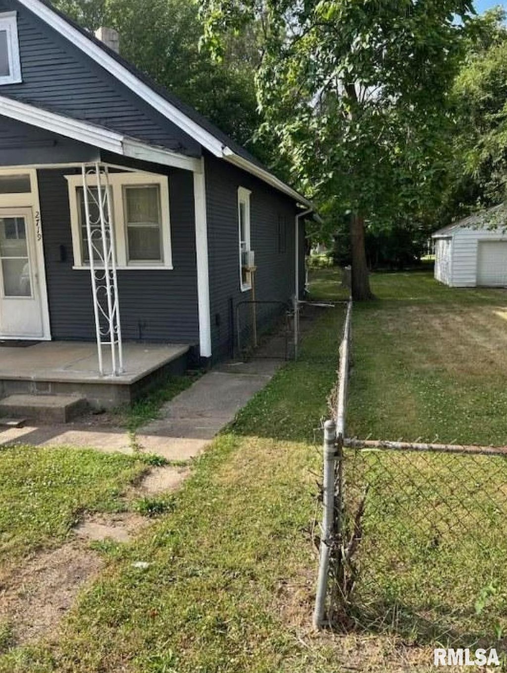 view of side of property with a lawn and a porch