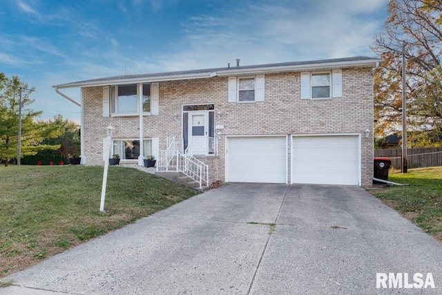 split foyer home with a front yard and a garage