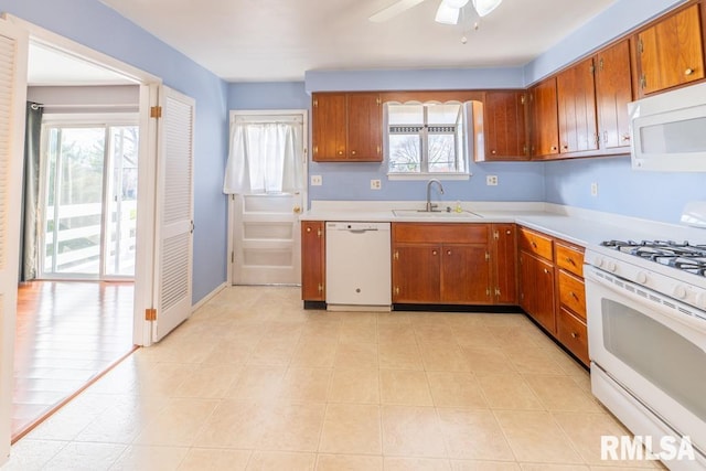 kitchen featuring ceiling fan, plenty of natural light, white appliances, and sink