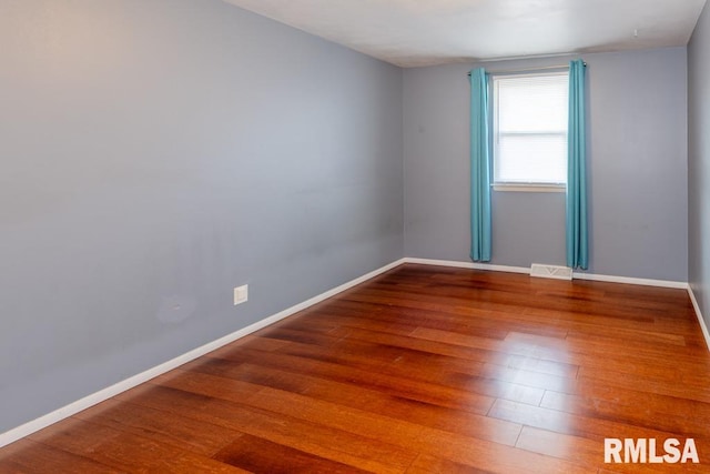 unfurnished room with hardwood / wood-style floors