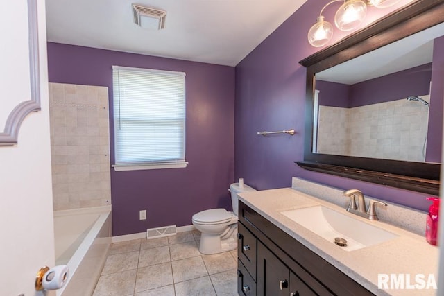 full bathroom featuring tile patterned floors, tiled shower / bath, vanity, and toilet