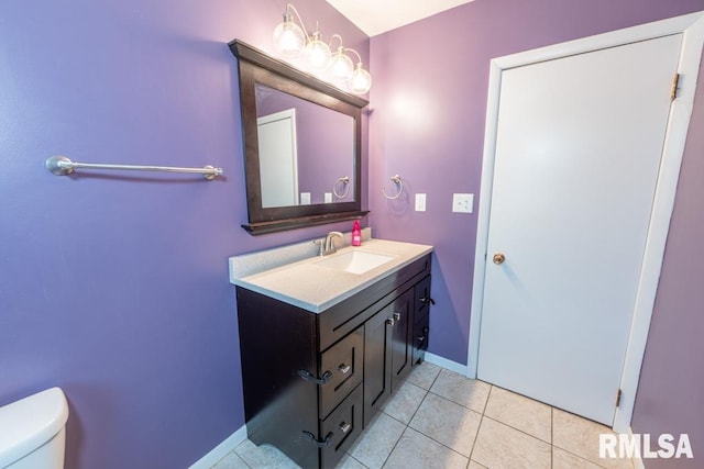 bathroom featuring toilet, vanity, and tile patterned floors