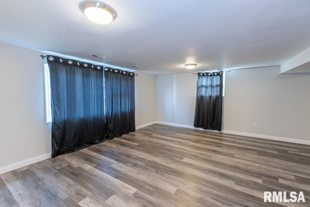 empty room featuring hardwood / wood-style flooring and a healthy amount of sunlight