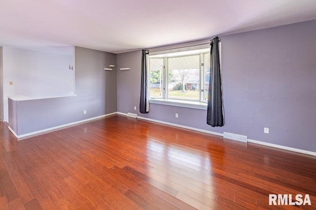 spare room with hardwood / wood-style floors