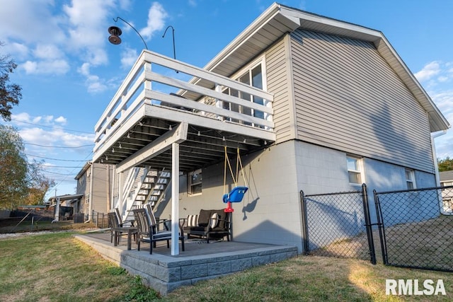 back of house with a yard, a patio, and a deck