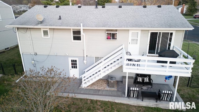 rear view of property featuring a patio and a deck