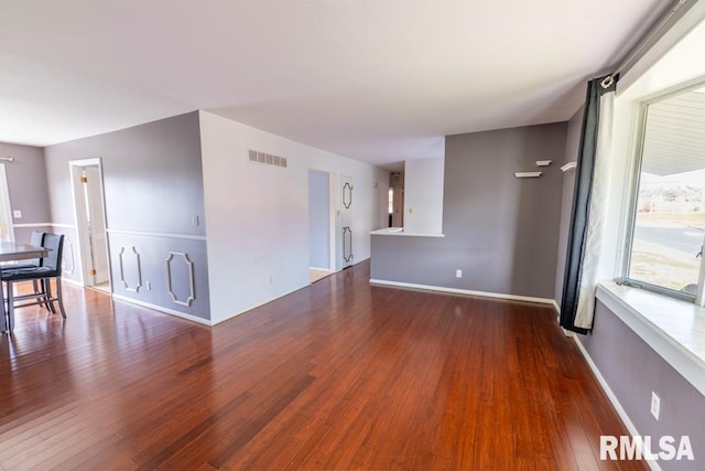 unfurnished living room featuring wood-type flooring