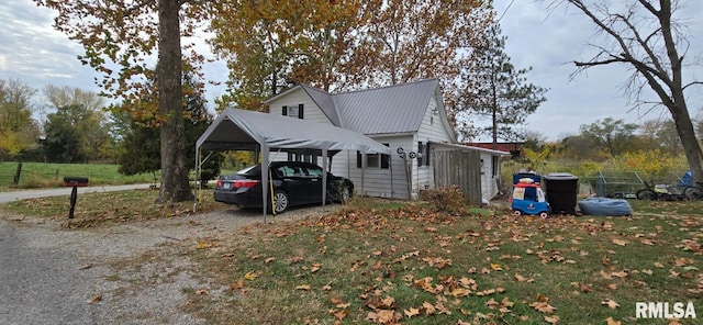 500 E Bancroft St, West Point, IL 62380 - view of side of home featuring driveway, metal roof, and a carport