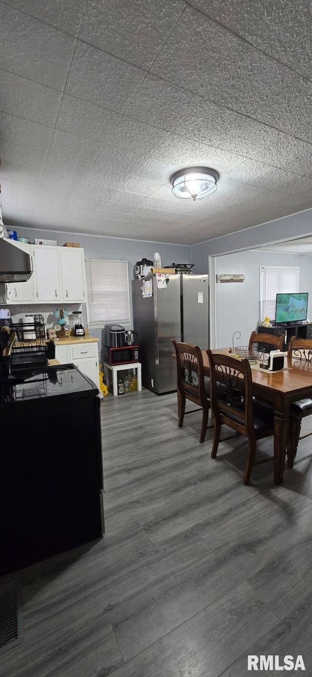 dining area with dark hardwood / wood-style flooring