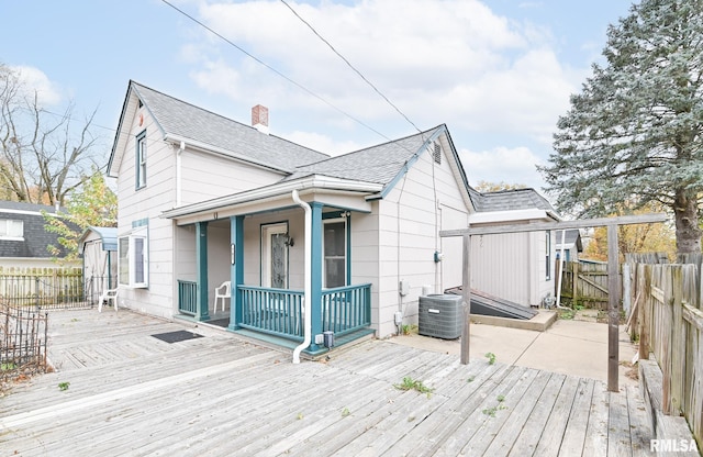 exterior space with central AC unit and fence