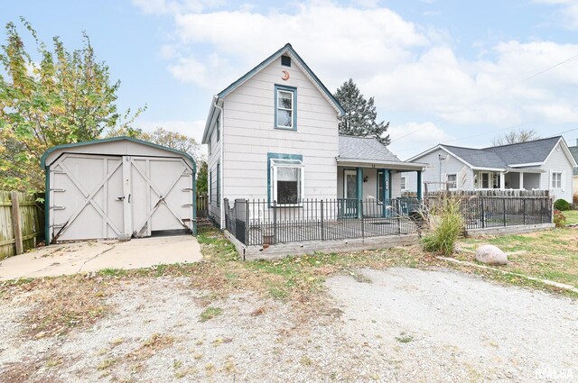 exterior space featuring a garage, an outdoor structure, a deck, and a front lawn