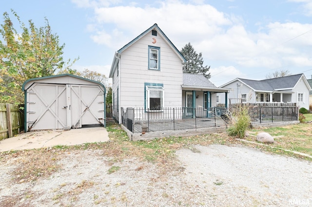 view of front of house with fence private yard, a shed, and an outbuilding