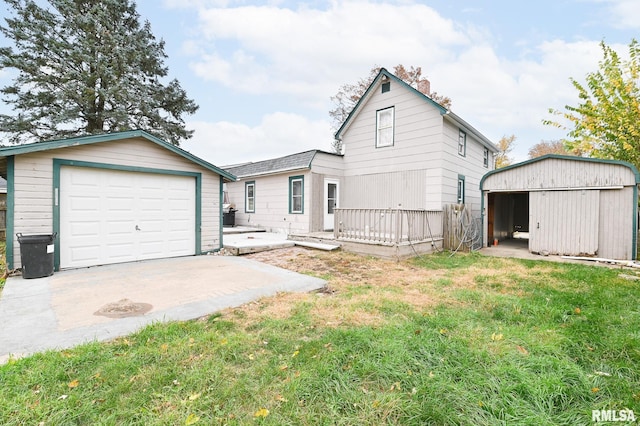 view of front facade featuring a garage, concrete driveway, a chimney, an outdoor structure, and a front lawn