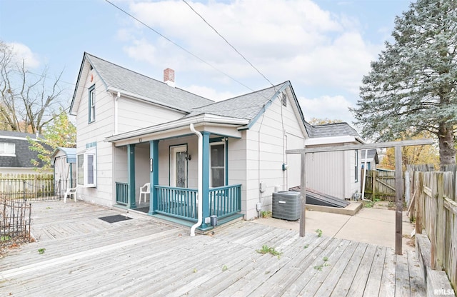 exterior space featuring fence and central AC unit