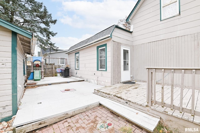 deck with fence, area for grilling, and a patio