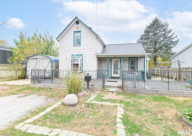 view of front facade with covered porch, an outdoor structure, fence, dirt driveway, and a shed