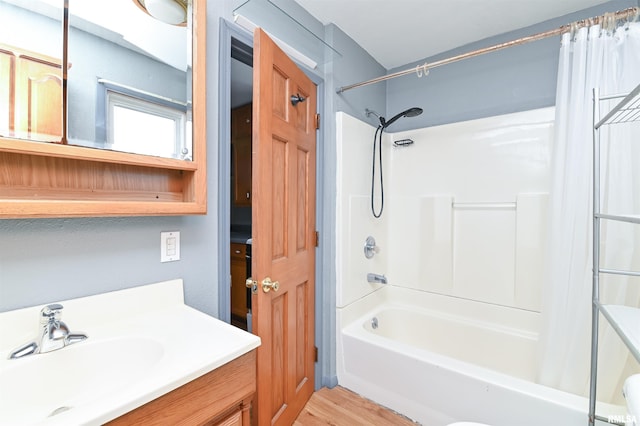 full bathroom featuring  shower combination, wood finished floors, and vanity