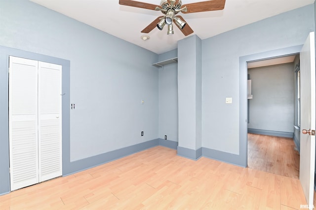 unfurnished bedroom featuring a ceiling fan, baseboards, and wood finished floors