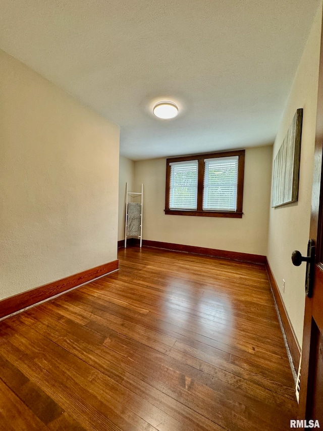 spare room featuring hardwood / wood-style flooring