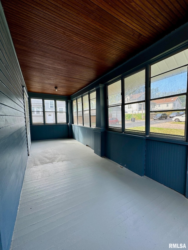 unfurnished sunroom with wooden ceiling