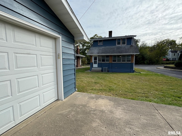 garage featuring a lawn