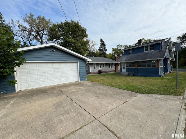 view of front of property featuring a garage and a front lawn