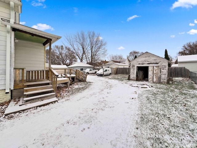 yard layered in snow with a shed