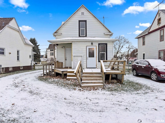 view of snow covered rear of property