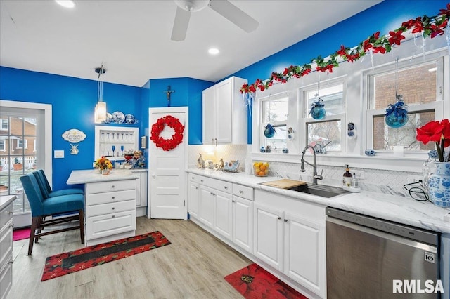 kitchen with white cabinets, dishwasher, a healthy amount of sunlight, and decorative light fixtures