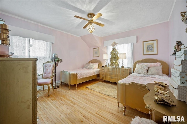 bedroom featuring wood-type flooring, a textured ceiling, ceiling fan, and crown molding