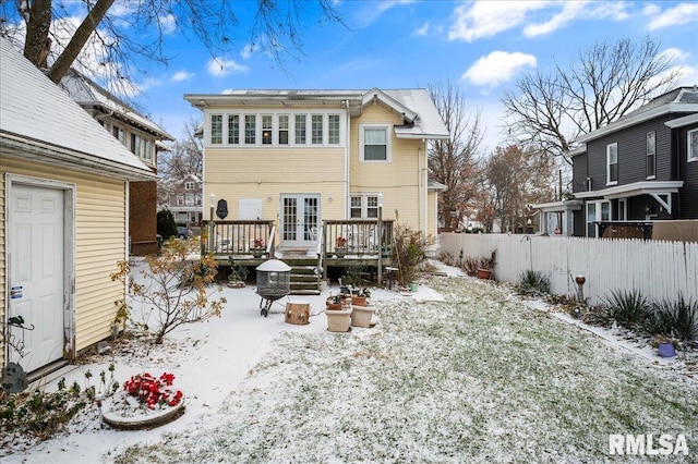 snow covered property featuring french doors and a deck