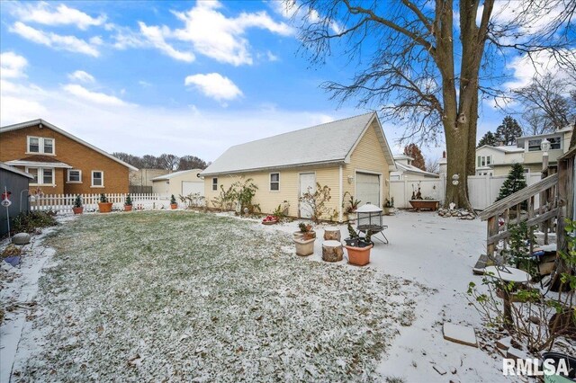 exterior space featuring an outbuilding, a garage, and a lawn