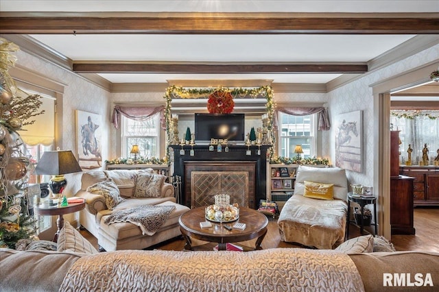 living area featuring beam ceiling, crown molding, and hardwood / wood-style floors