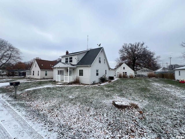 view of snow covered back of property