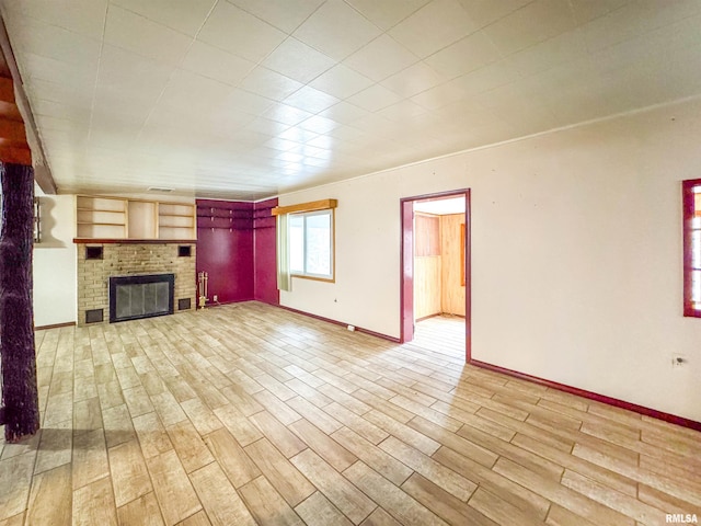 unfurnished living room with a fireplace and light hardwood / wood-style floors